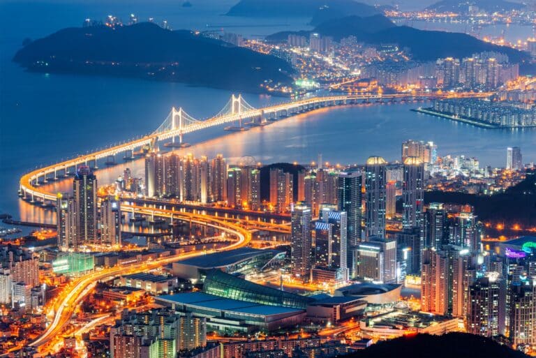 Night view of Gwangan Bridge glowing over Busan city lights