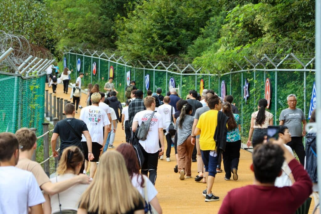 Tourists walking along designated path near DMZ border fence