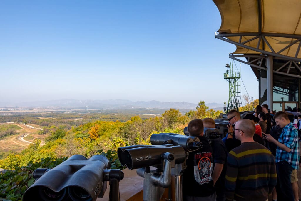 Visitors using binoculars at Dora Observatory looking into North Korea