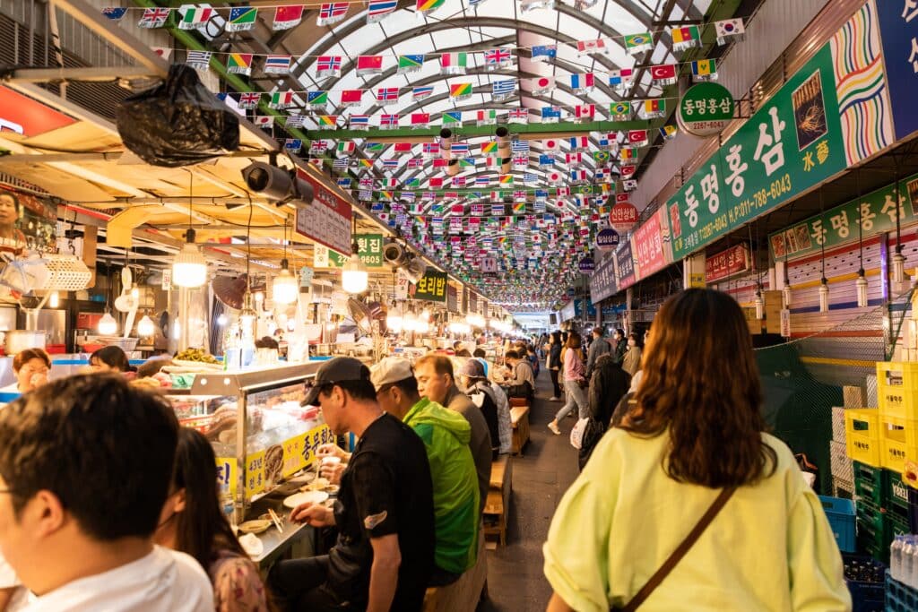 Busy food stalls and diners inside Gwangjang Market in Seoul, South Korea