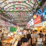 Busy Gwangjang Market in Seoul filled with street food stalls and visitors