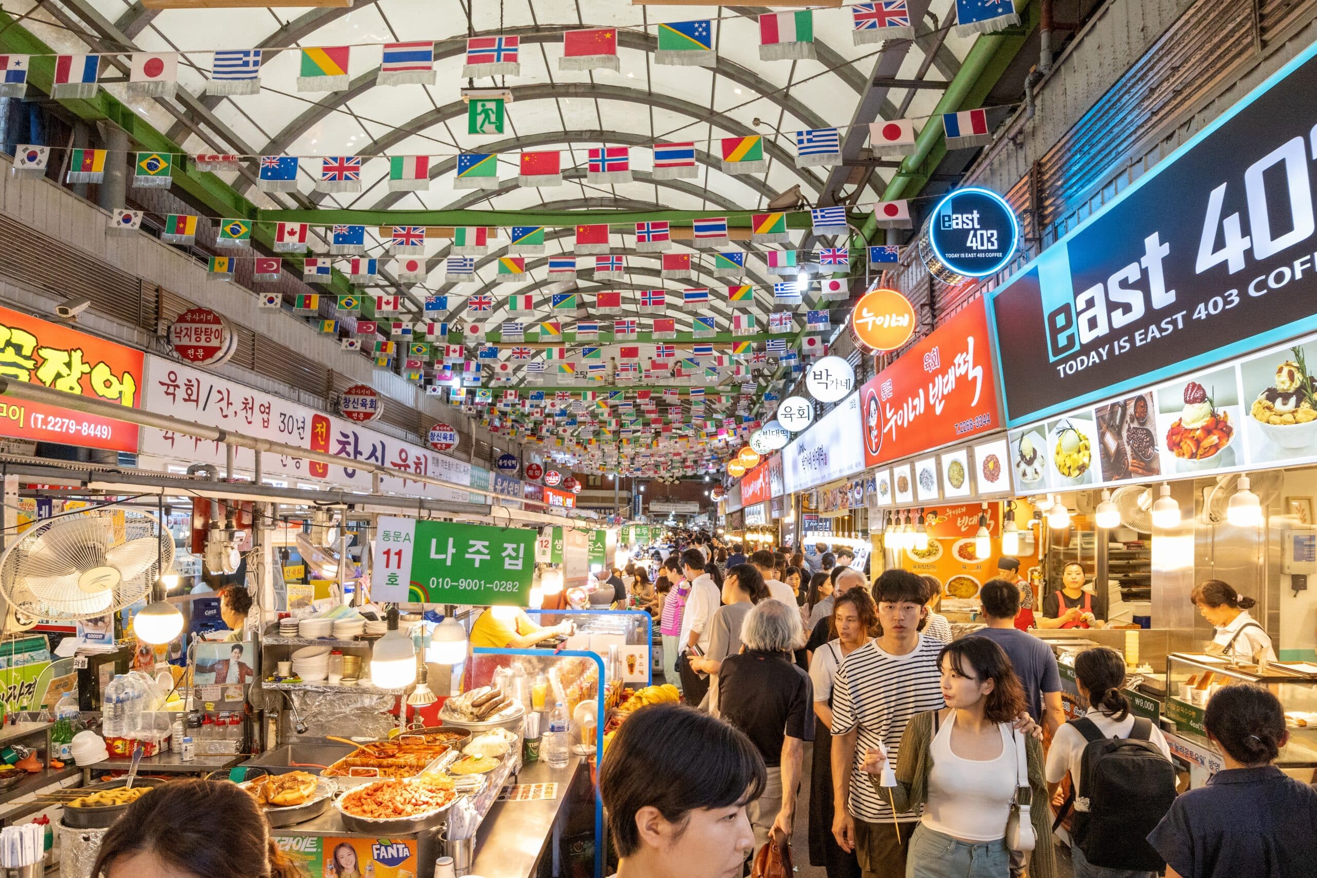 Busy Gwangjang Market in Seoul filled with street food stalls and visitors