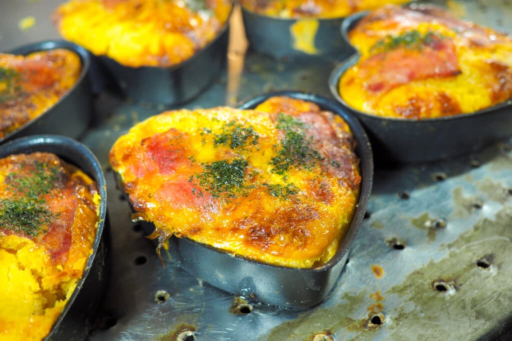 Korean gyeran bread with egg and cheese baked in small molds at a street food stall