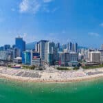 Aerial view of Haeundae Beach with turquoise water and city skyline