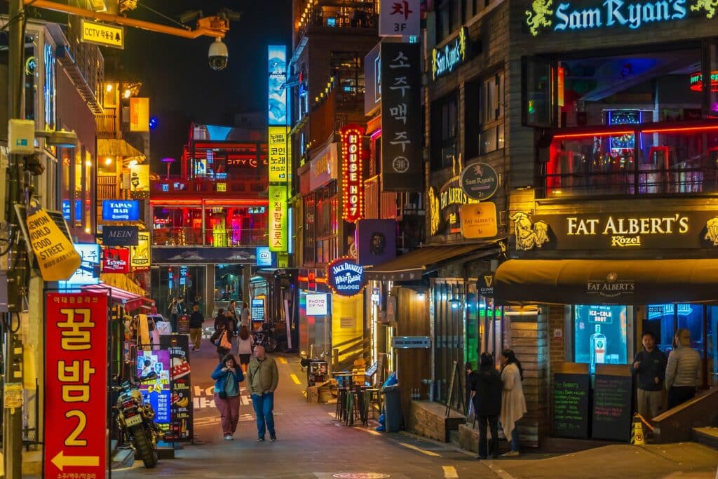 Busy nightlife street in Itaewon Seoul with bars, restaurants, and neon signs