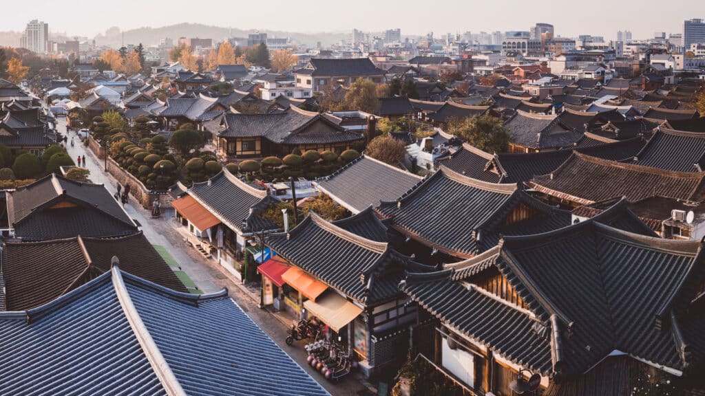 Aerial view of Jeonju Hanok Village with traditional Korean rooftops at sunset