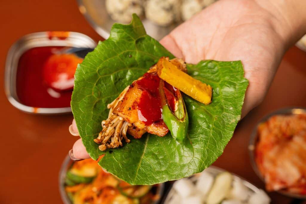 Korean barbecue wrap with grilled meat vegetables and sauce