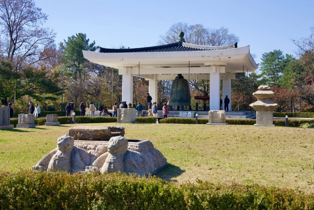 Traditional bell pavilion in a park in South Korea with visitors