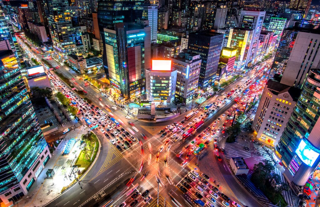 Aerial view of busy intersection in Seoul at night with city lights and traffic