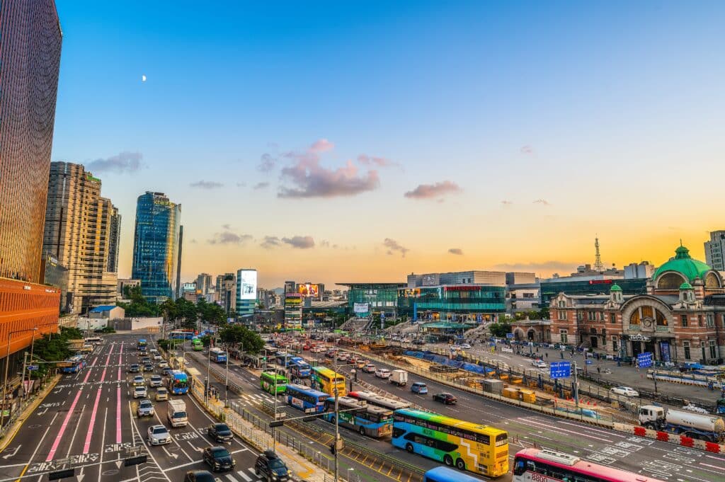 Busy street in Seoul with buses, cars and public transport at sunset in South Korea