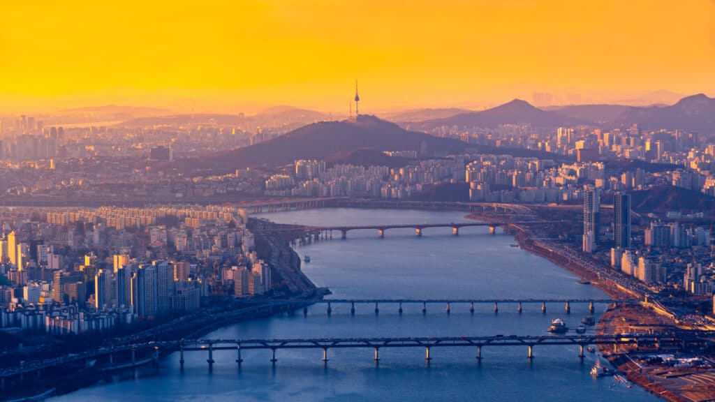 Aerial view of Seoul skyline, the Han River, and Namsan Seoul Tower at sunset