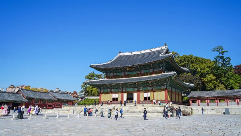 Historic palace building in Seoul with visitors in the courtyard