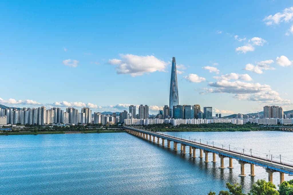 Seoul skyline with Lotte World Tower and Han River bridge in South Korea at sunset