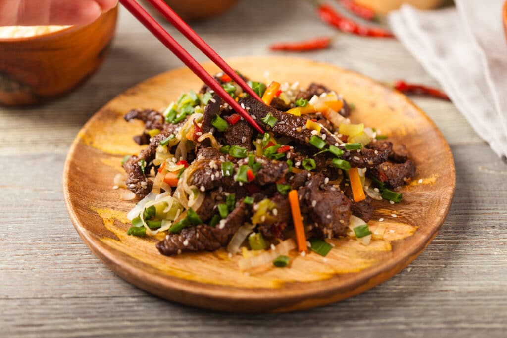 Traditional Korean Bulgogi dish. Thinly cut, grilled beef, served with rice and vegetables.