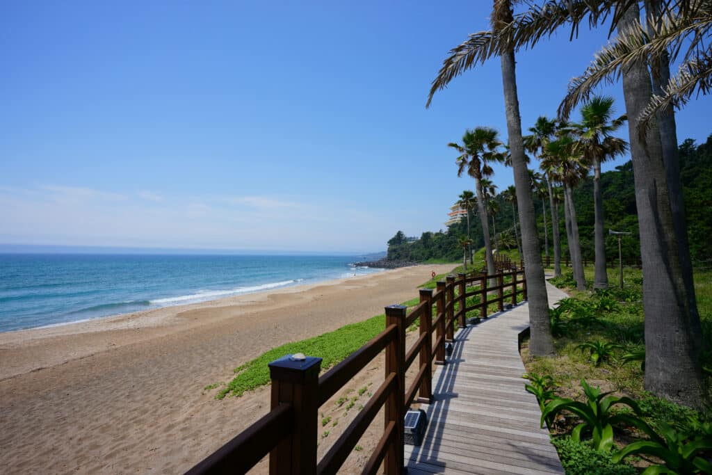 a beautiful seascape with a seaside boardwalk, scenery around jungmun saekdal beach