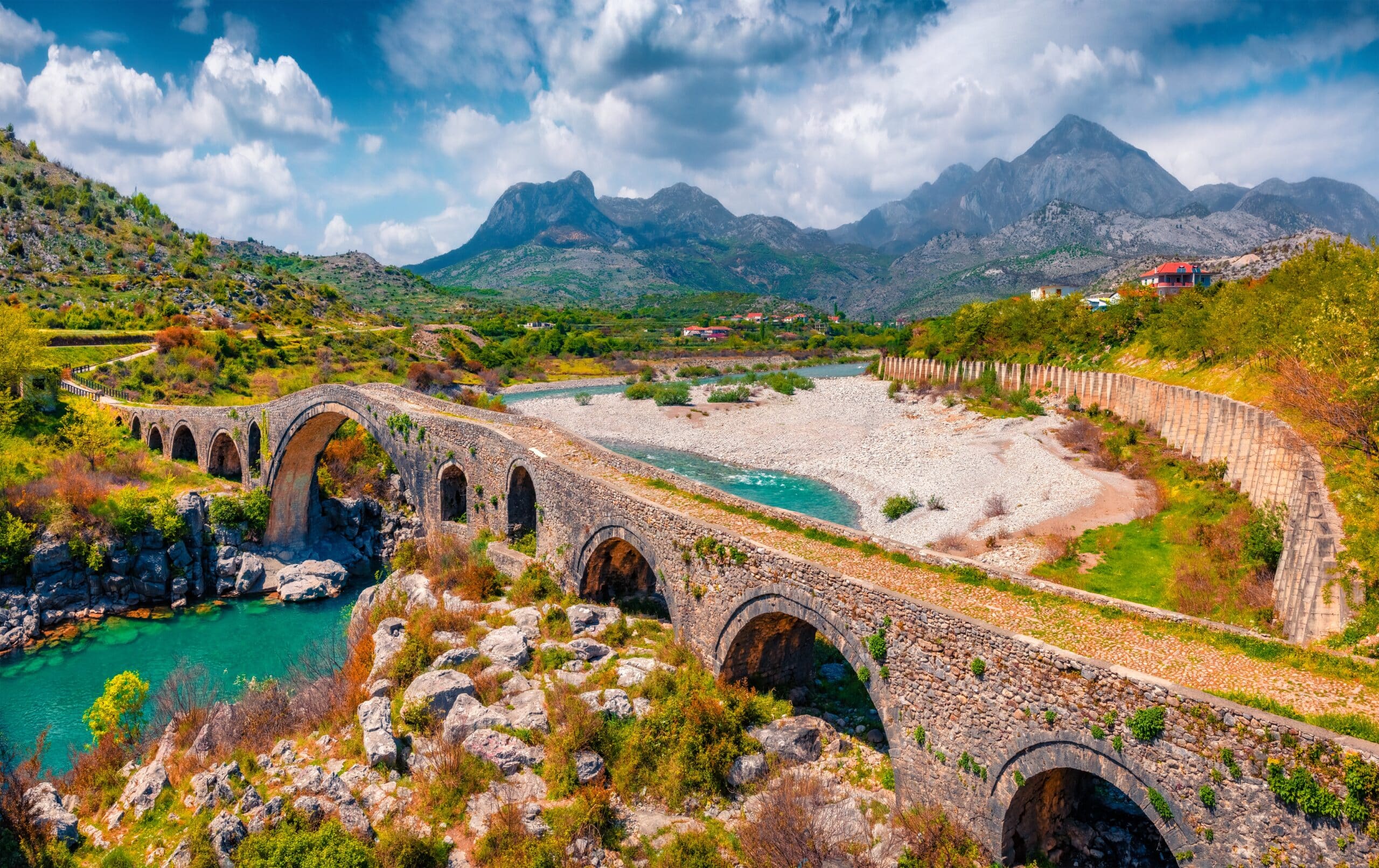 Beautiful spring view of Old Mes Bridge. Colorful morning landscape of Shkoder. Amazing outdoor scene of Albania, Europe. Traveling concept background.