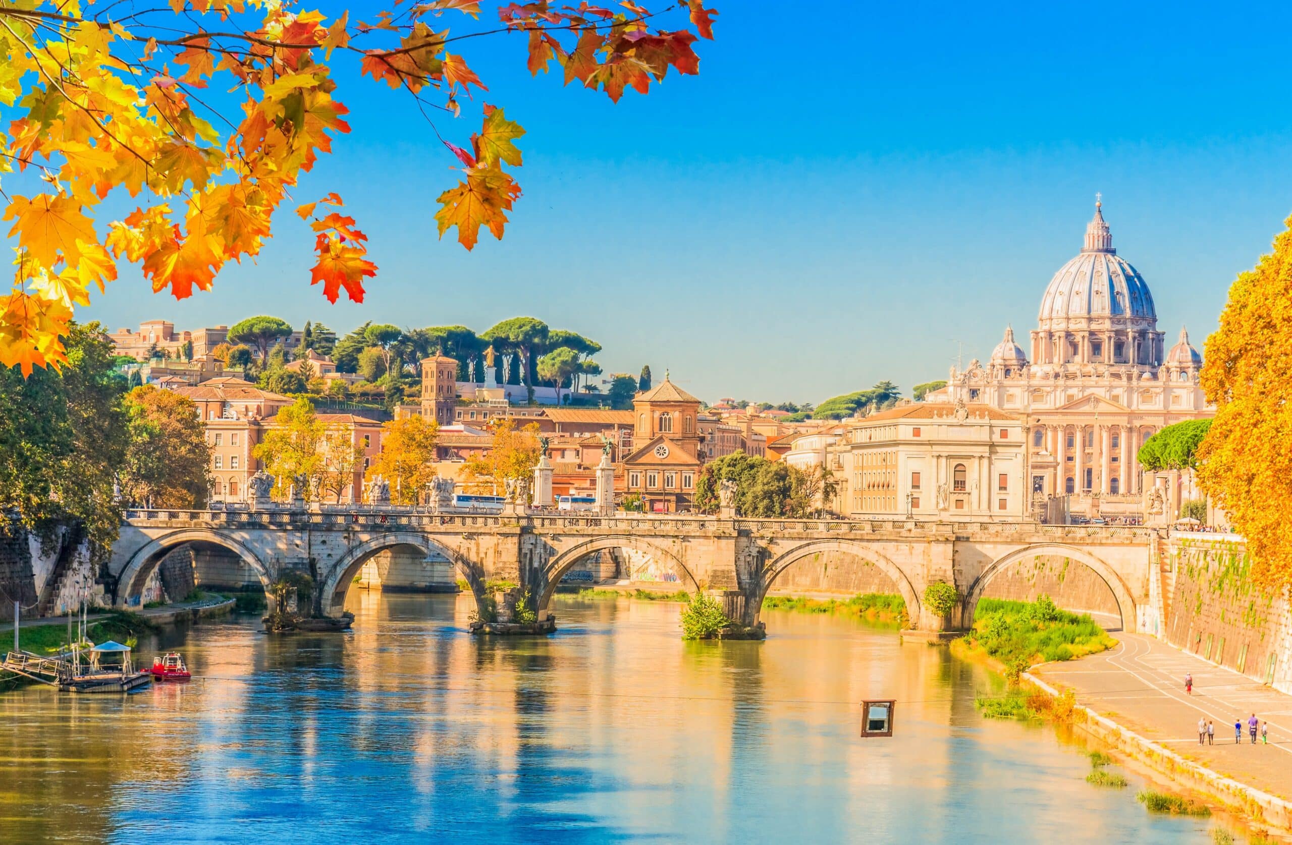 St. Peter's cathedral over bridge and river water at fall day Rome, Italy