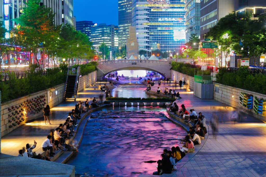 Colorful city lights of Cheonggyecheon Stream Park with Crowd at night in Seoul City, South Korea.
