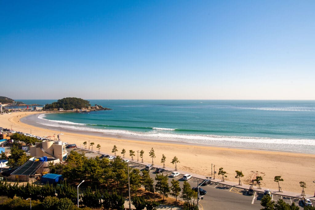 Wide view of Songjeong Beach coastline with clear water in Busan