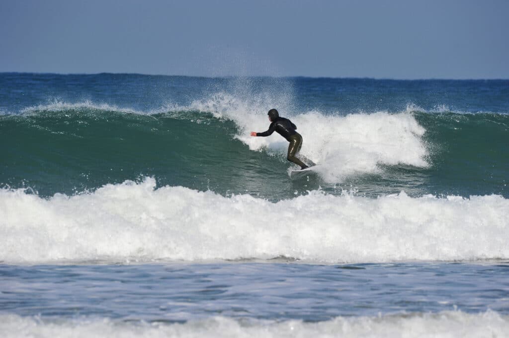 Surfer riding waves at Songjeong Beach in Busan South Korea