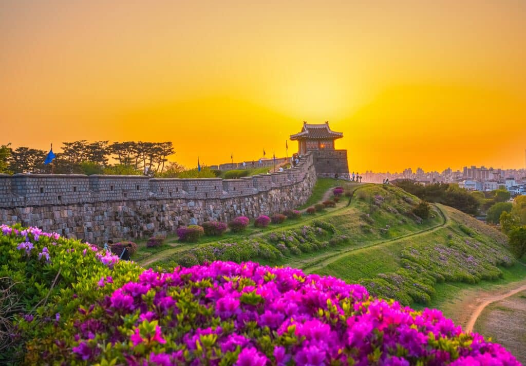 Stone walls and watchtower at Suwon Hwaseong Fortress during sunset