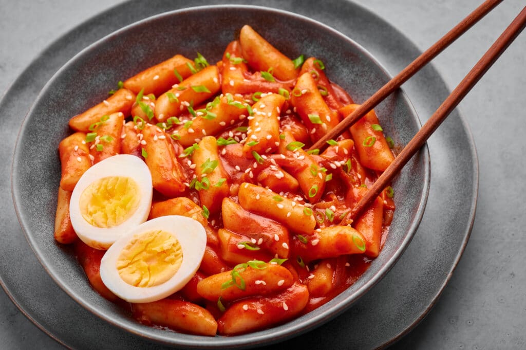 Tteokbokki Korean spicy rice cakes with egg and sesame seeds