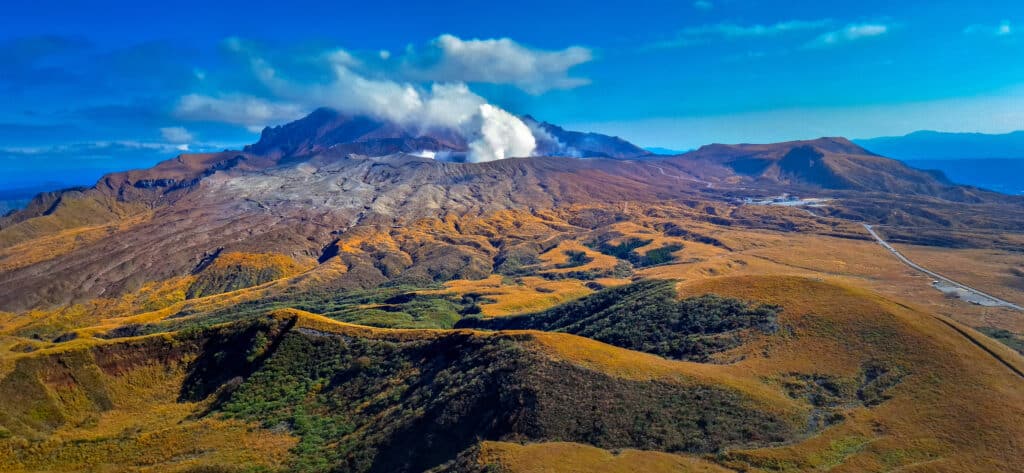 Aerial view of Mount Aso volcano with crater and surrounding landscape in Japan