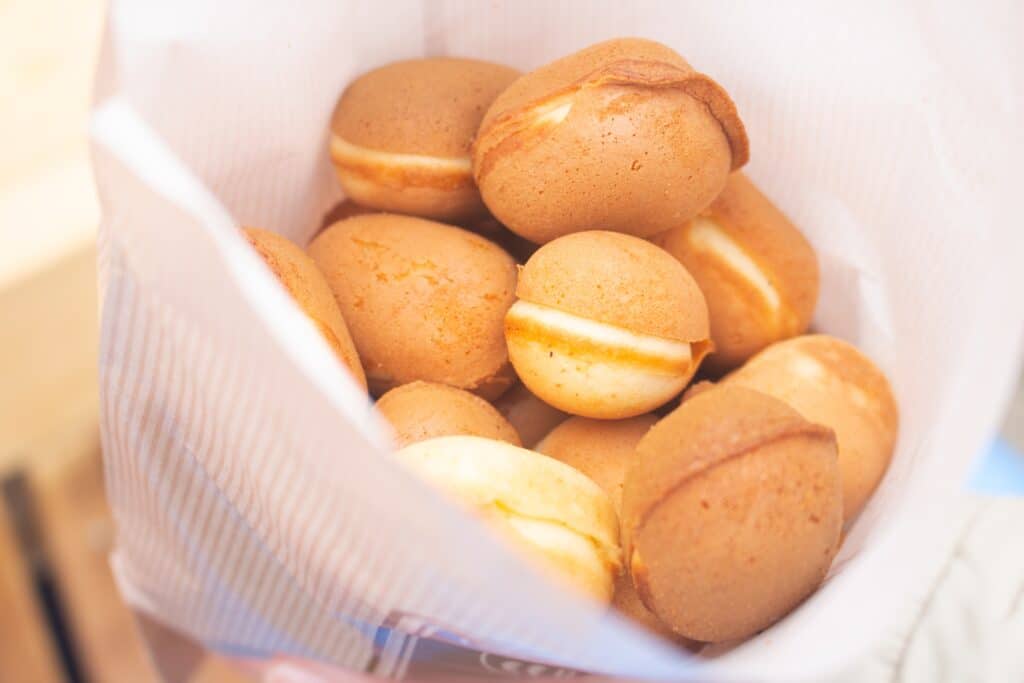 Baby castella sponge cakes served in a paper bag at a Japanese festival