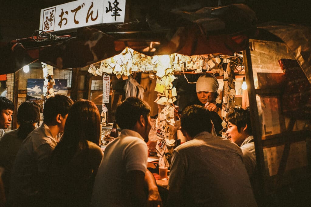 People dining at a traditional yatai street food stall in Fukuoka, Japan