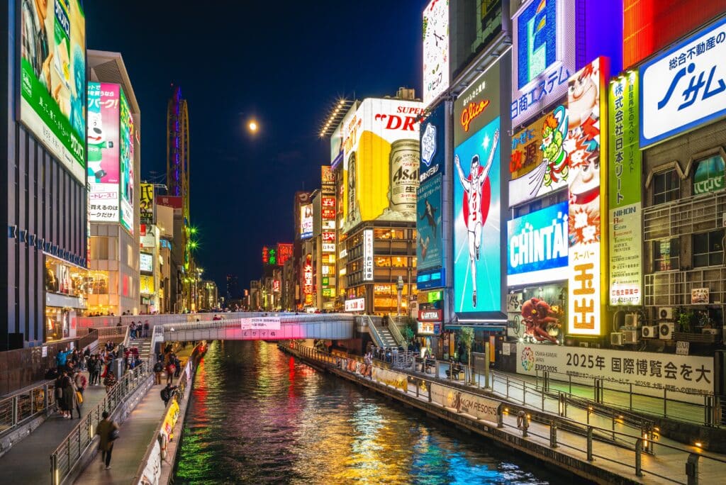 Dotonbori canal at night with neon lights and famous Glico running man sign