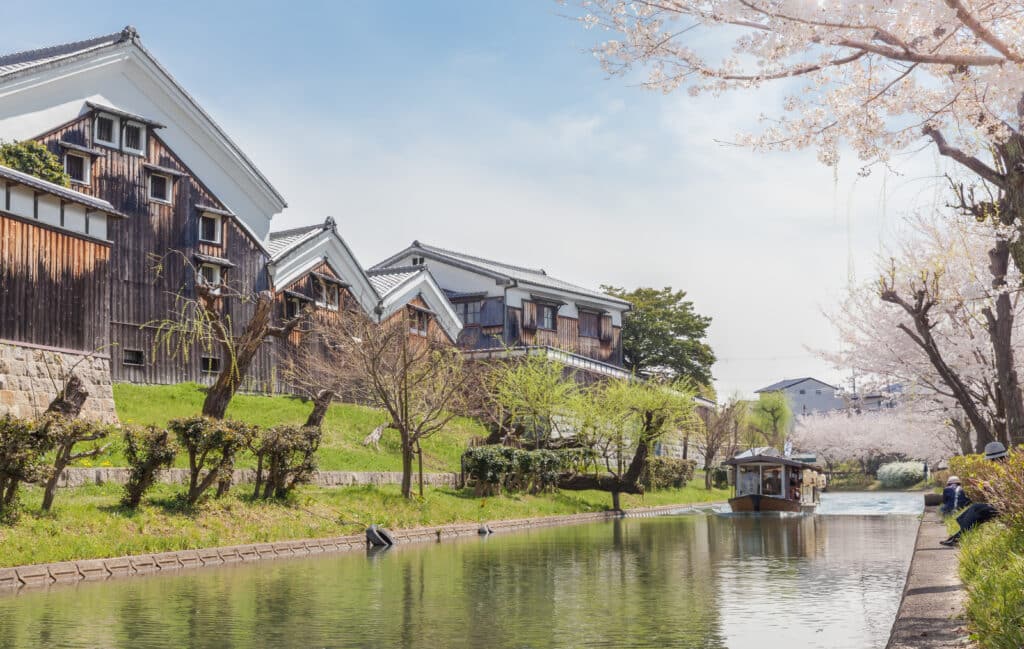 canal in Fushimi sake district Kyoto with traditional warehouses and boat