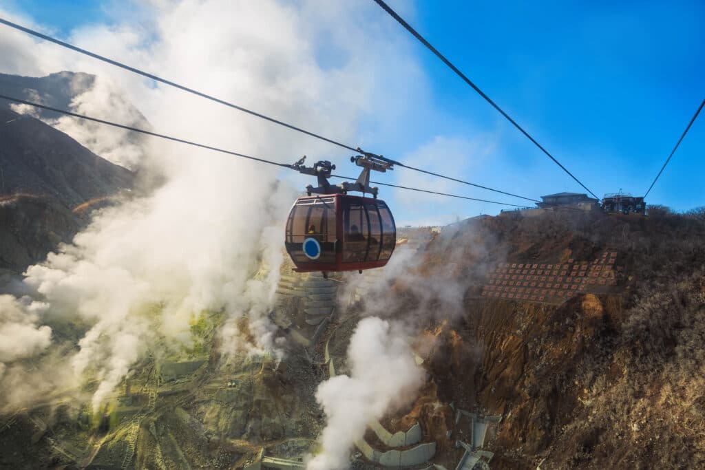 Hakone Ropeway passing above the steaming volcanic landscape of Owakudani, Japan