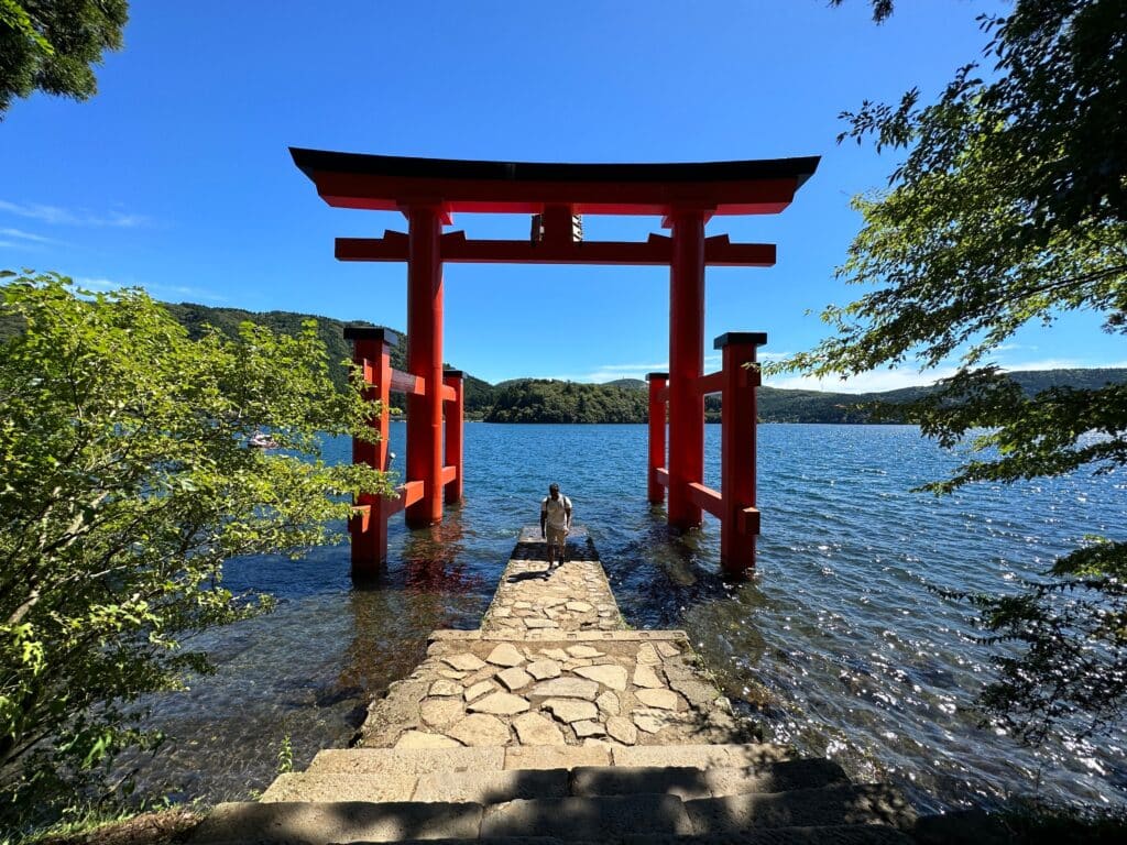 Red torii gate standing in Lake Ashi in Hakone Japan
