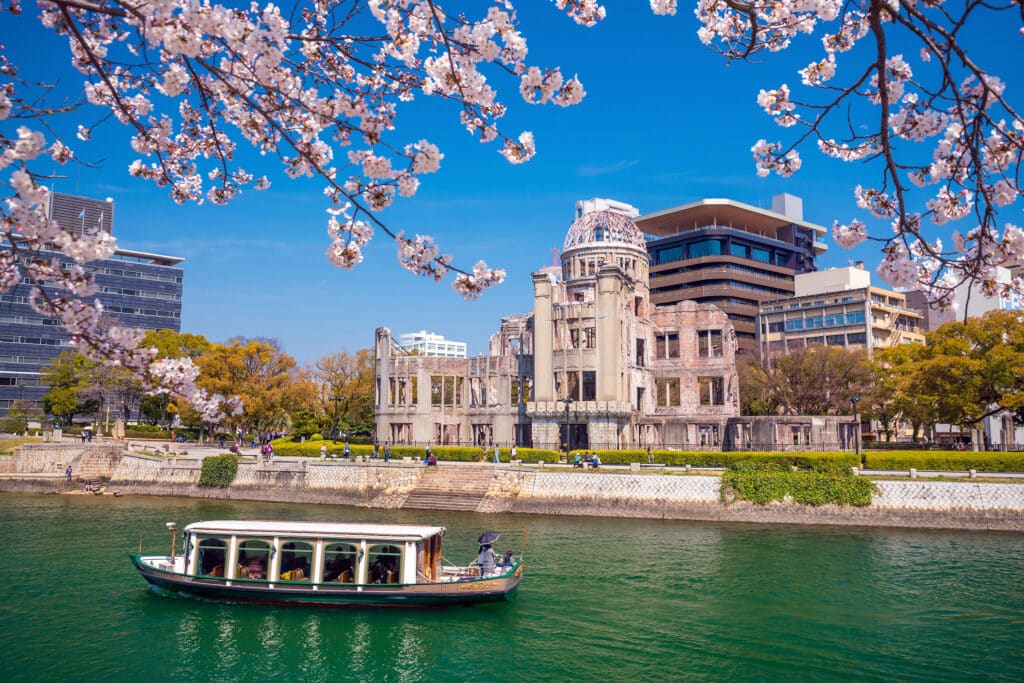 Atomic Bomb Dome in Hiroshima framed by cherry blossoms in spring, Japan