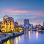 Hiroshima Atomic Bomb Dome illuminated at sunset with river reflections
