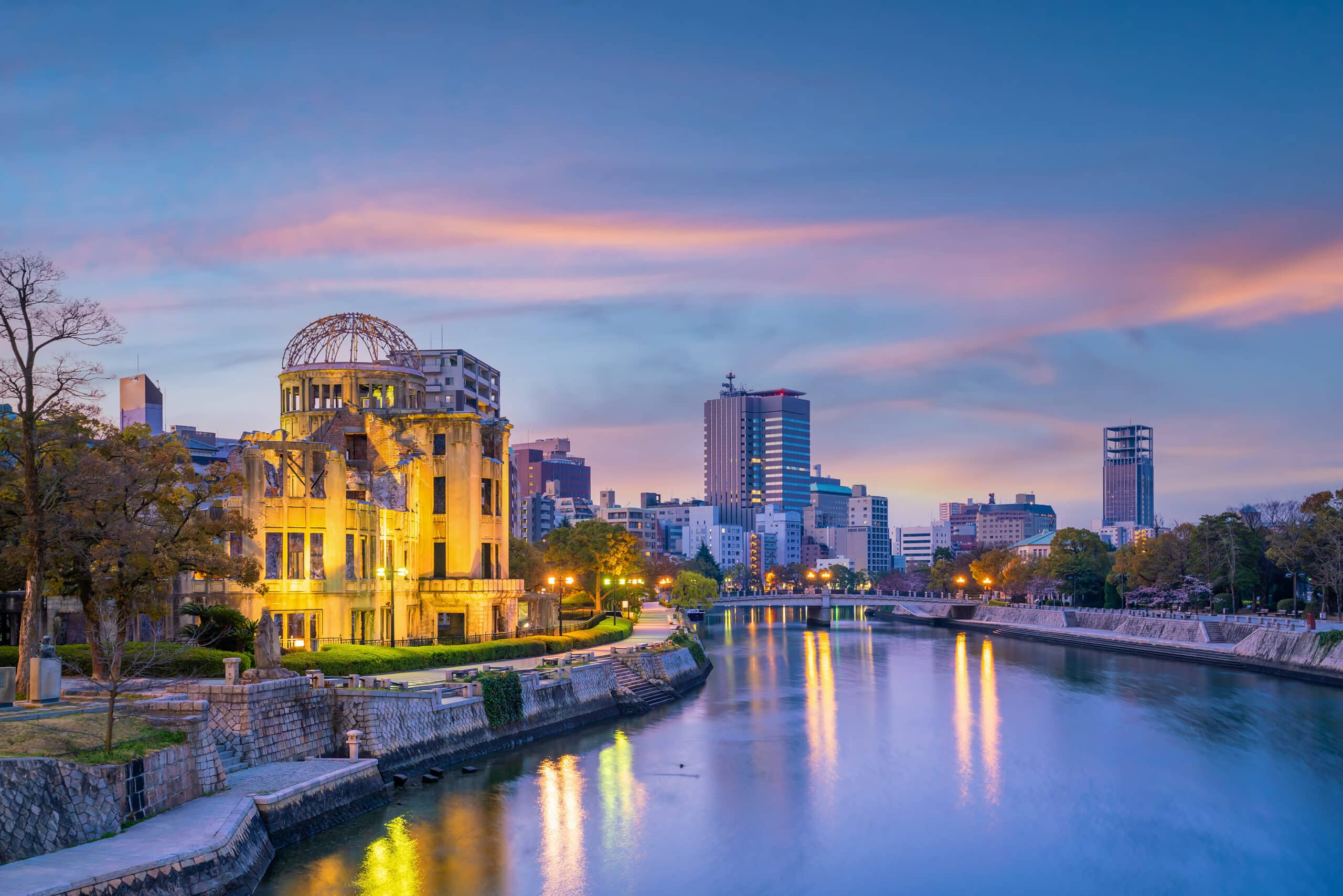 Hiroshima Atomic Bomb Dome illuminated at sunset with river reflections