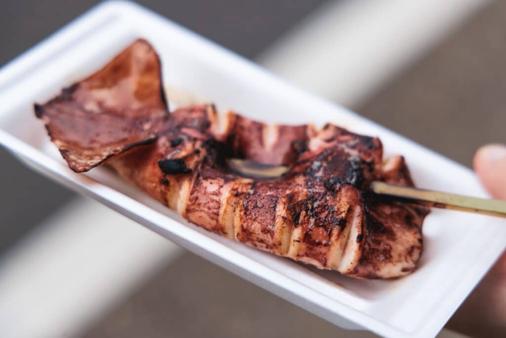 Ikayaki grilled squid on a skewer served at a Japanese street stall