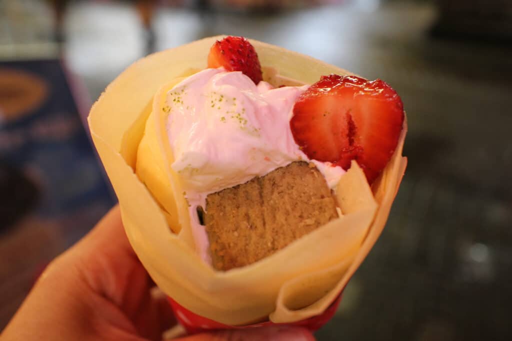 Japanese crepe filled with strawberries, whipped cream and cake