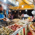 Japanese seafood street food stall with grilled skewers at a night festival