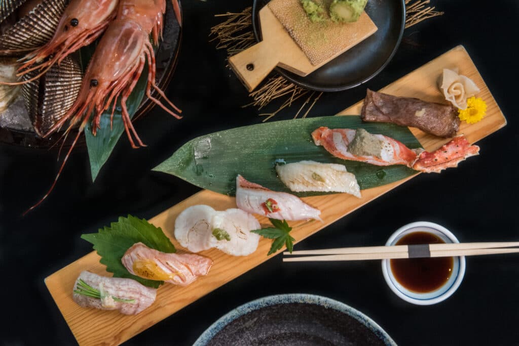 Japanese sushi and sashimi assortment with fresh seafood and dipping sauce
