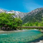 Kappa Bridge in Kamikochi with mountains and river