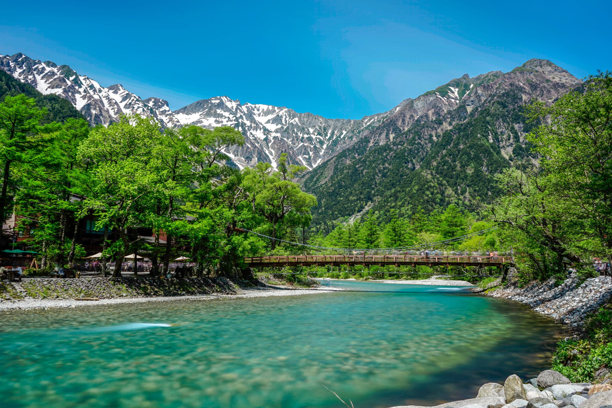 Kappa Bridge in Kamikochi with mountains and river