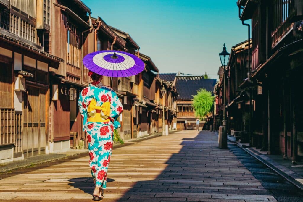 Woman in kimono walking through traditional street in Kanazawa
