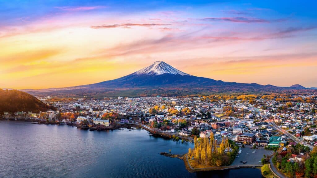 Mount Fuji reflected in Lake Kawaguchiko with town in foreground