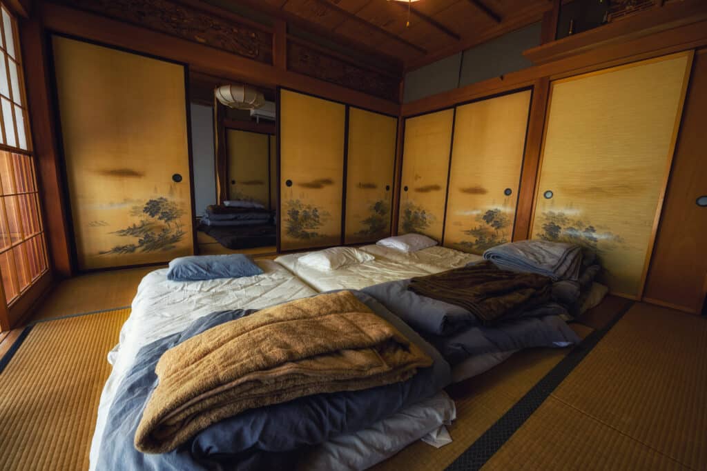 traditional Japanese ryokan room in Kyoto with futon beds and tatami mats