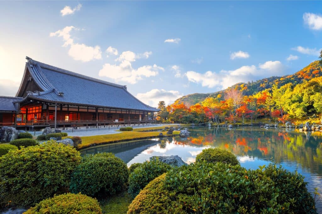 Zen temple garden with pond and autumn colors in Kyoto