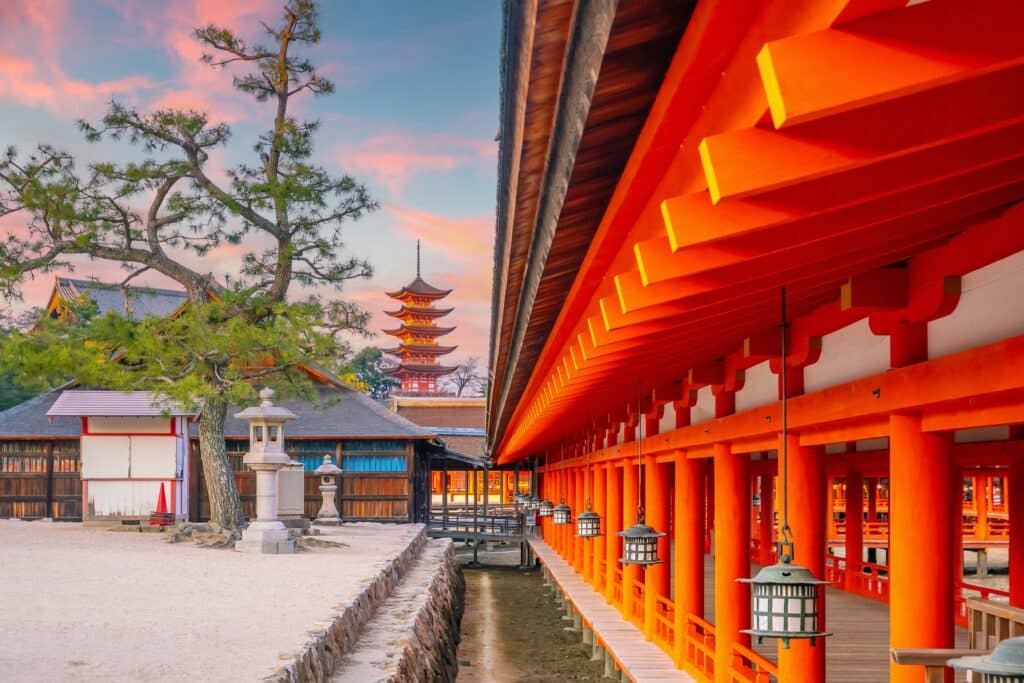 Itsukushima Shrine corridor on Miyajima island with red pillars at sunset