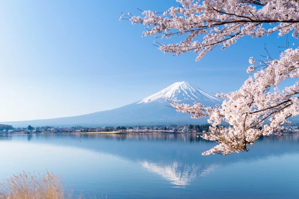 Mount Fuji reflected in Lake Kawaguchiko with autumn leaves