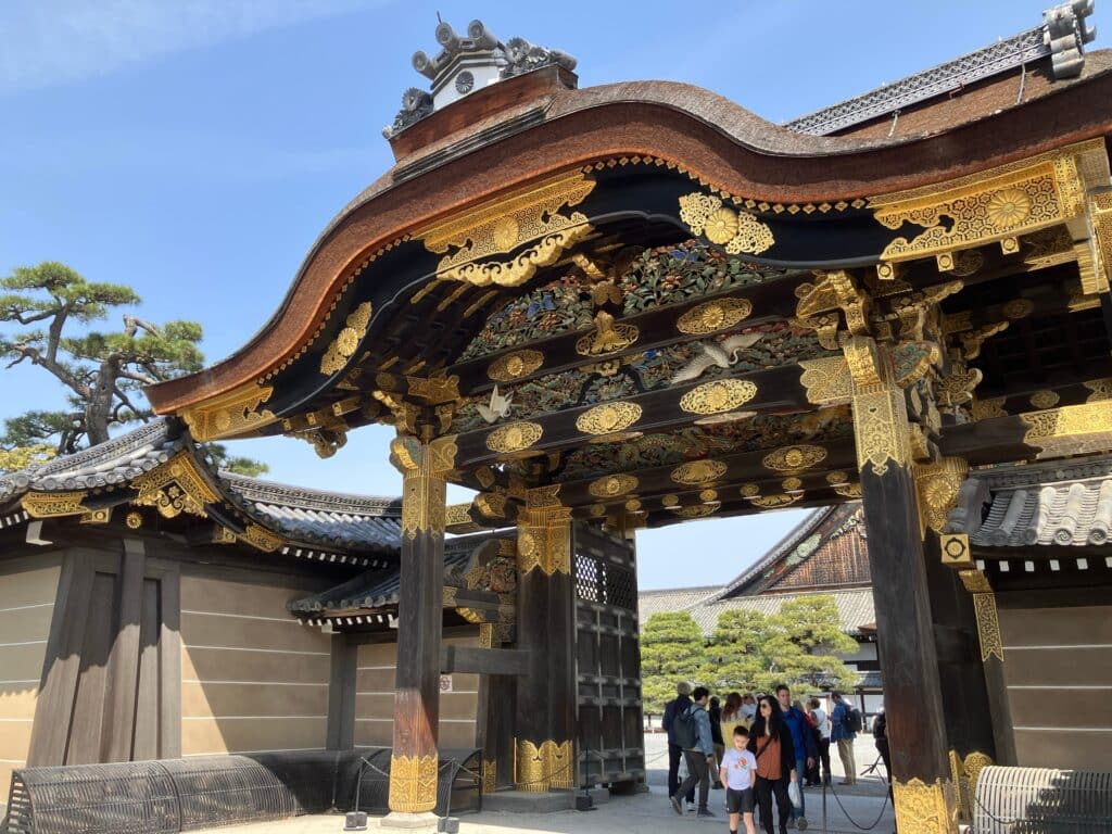 ornate entrance gate of Nijo Castle in Kyoto with gold details