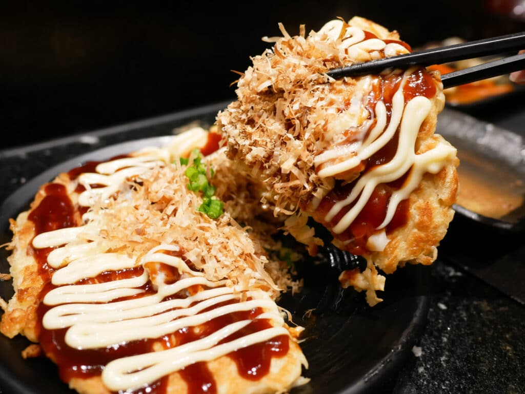 Okonomiyaki Japanese savory pancake with sauce mayonnaise and bonito flakes
